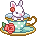 A pixel of a mint green teacup on a plate with a red rose on its side. There's a white rabbit with a flower on its ear in the cup.